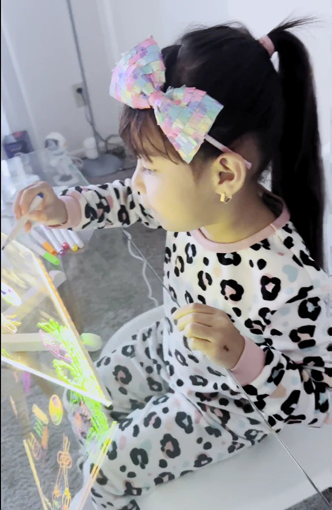 Mariam's daughter drawing on the KidoraX board